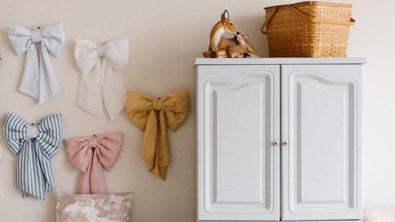 Big bows pinned to wall in white room