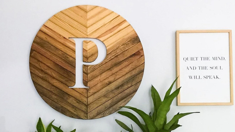 P carved into wooden sign