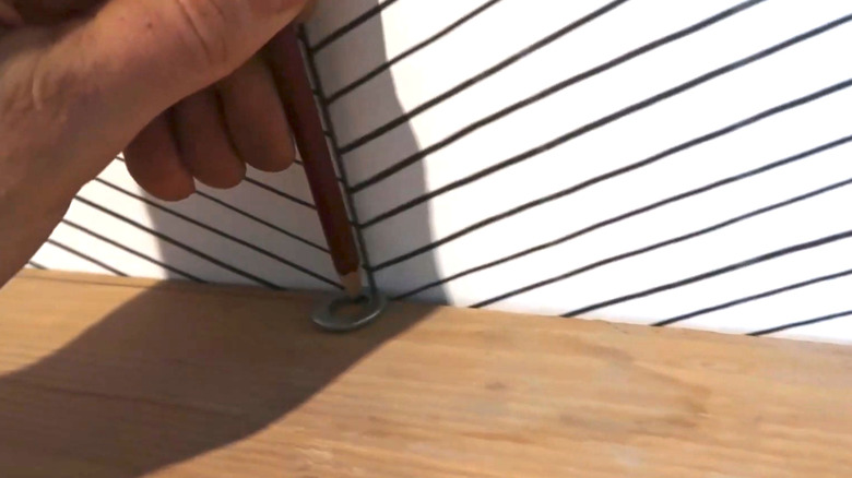 Scribing wall imperfections onto a shelf with a washer