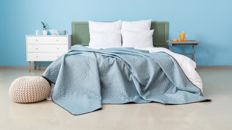 Blue bedroom with green headboard