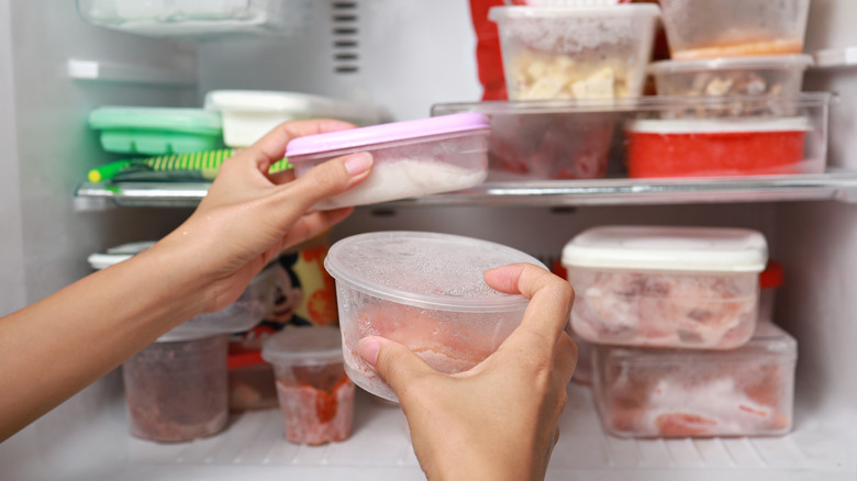 woman removing frozen contents