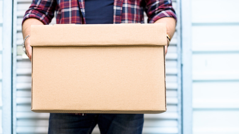 Man holding cardboard box