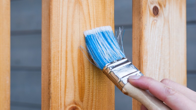 blue paint brush and wood