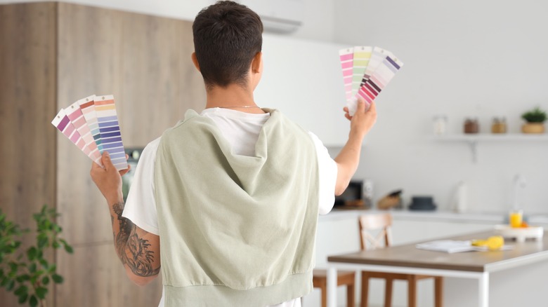 Man looking at paint samples