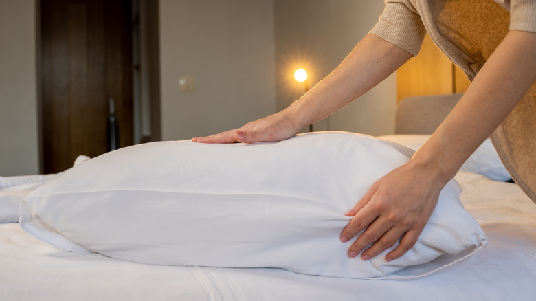 Hands arranging pillow