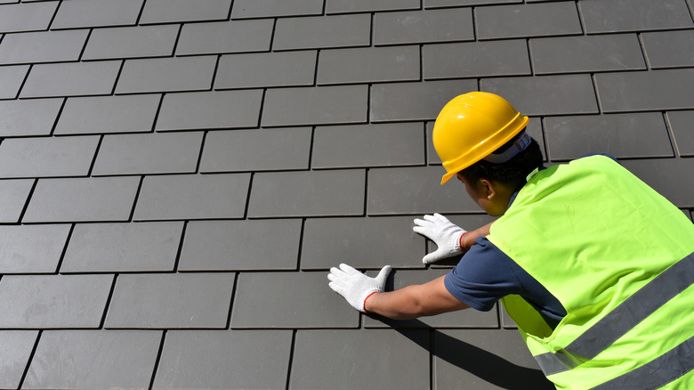 worker installing slate roof