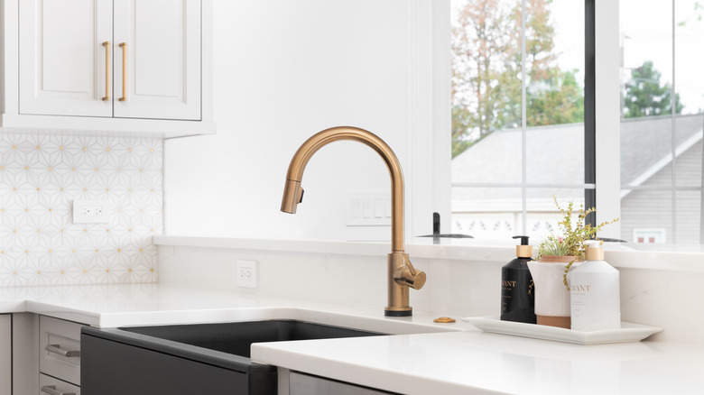 Kitchen sink with bronze faucet