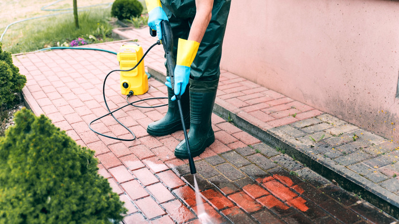 Person using pressure washer