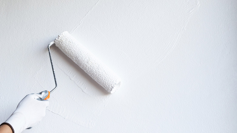 paint roller on white wall