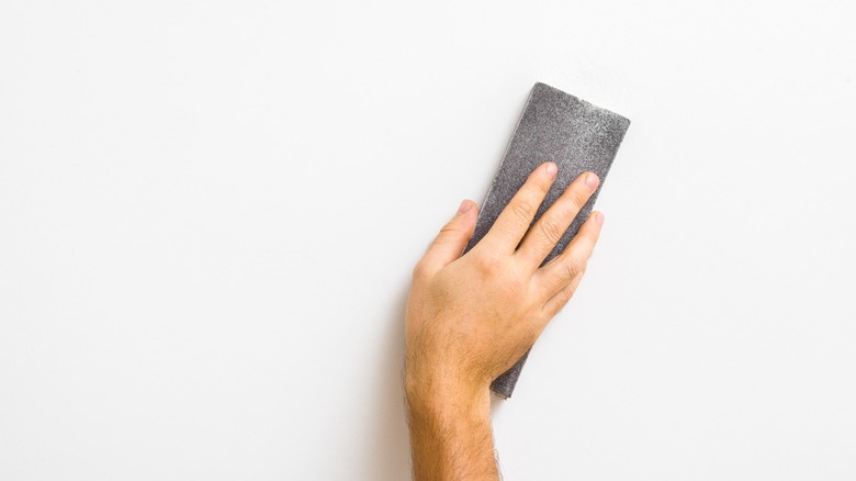 sanding block on white wall