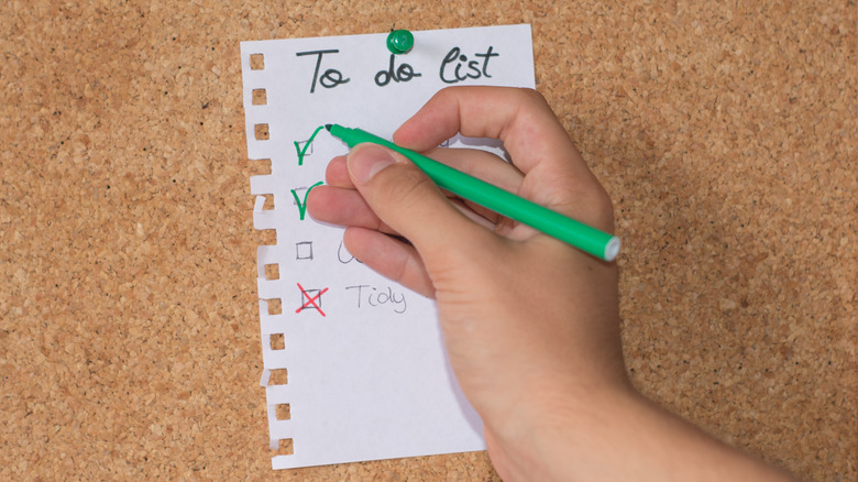 Person writing a to do list