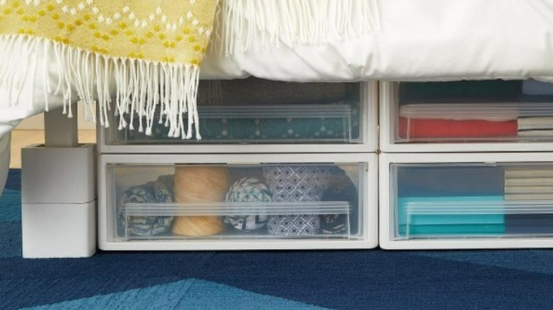 Bed on raisers with sliding drawer storage 