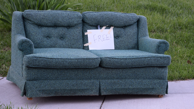 Loveseat on curb with "free" sign