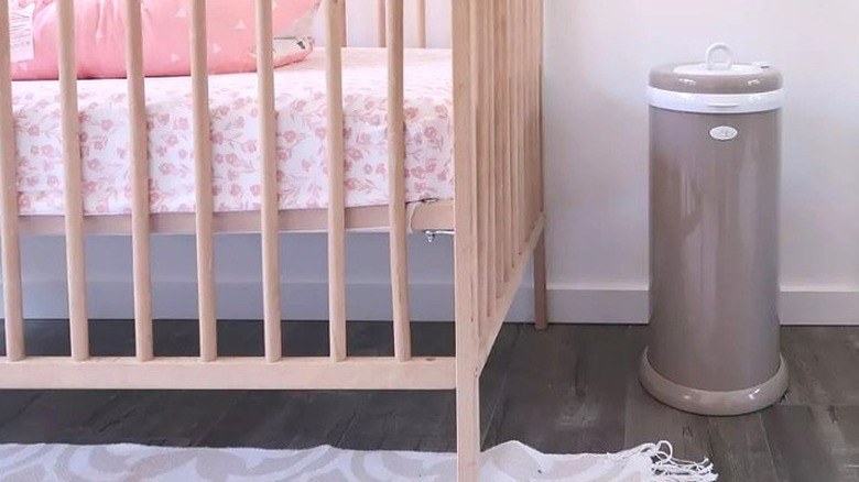 Diaper pail next to crib