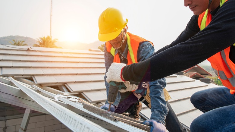 Workers sealing a roof