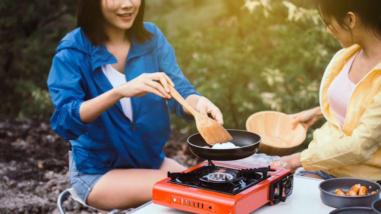 two women using camping stove