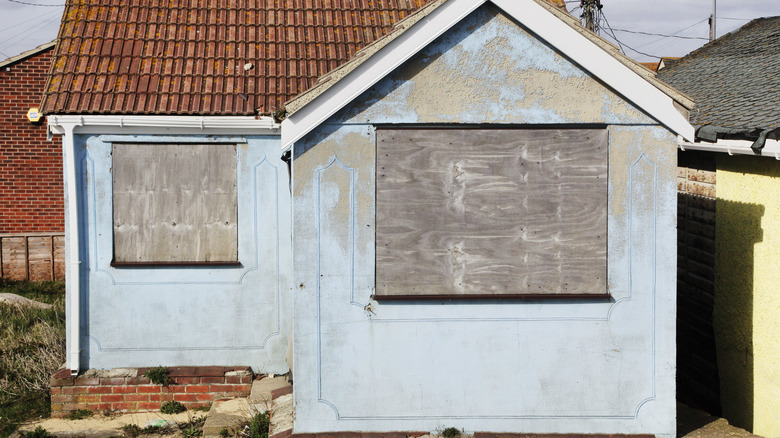 house with boarded up windows