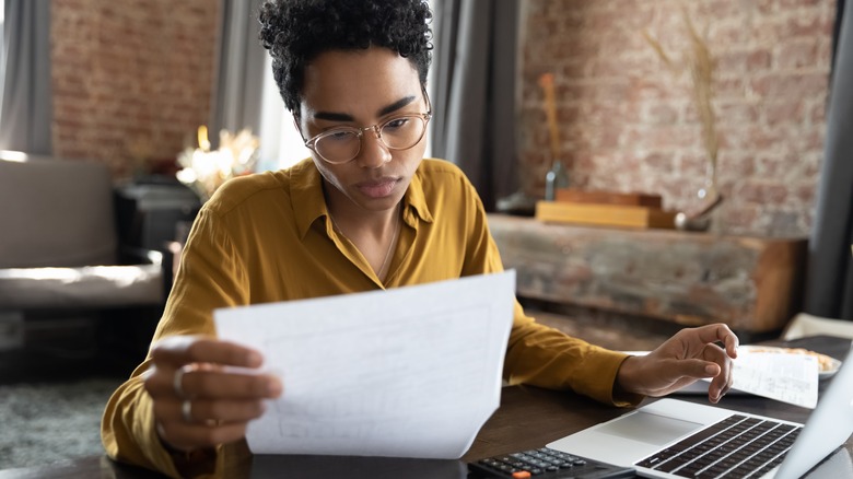 woman looking over papers