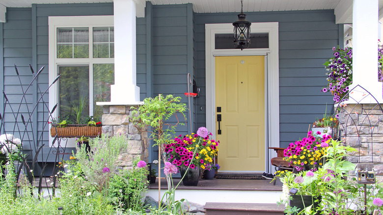 yellow front door with flowers