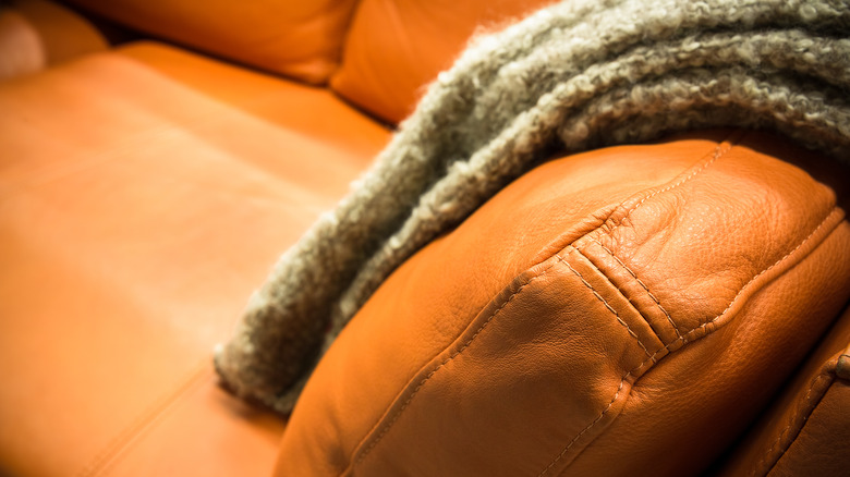 leather couch with blanket