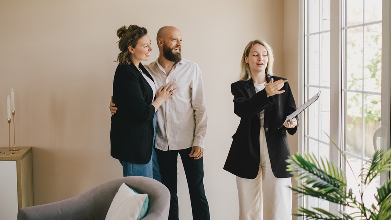 agent showing couple a home