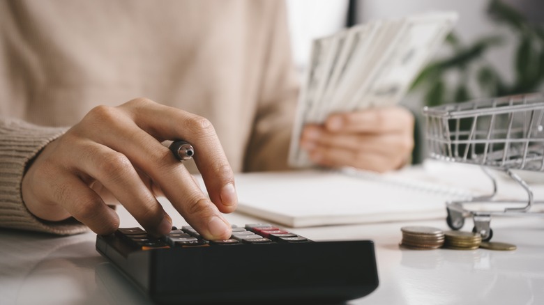 woman calculating budget on calculator 