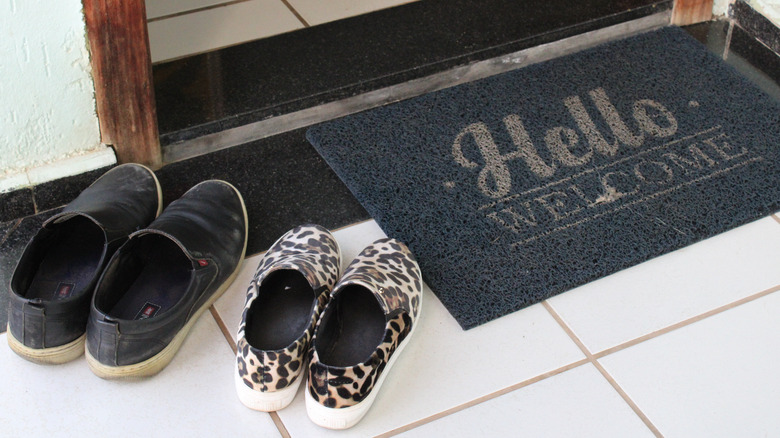 shoes outside next to doormat