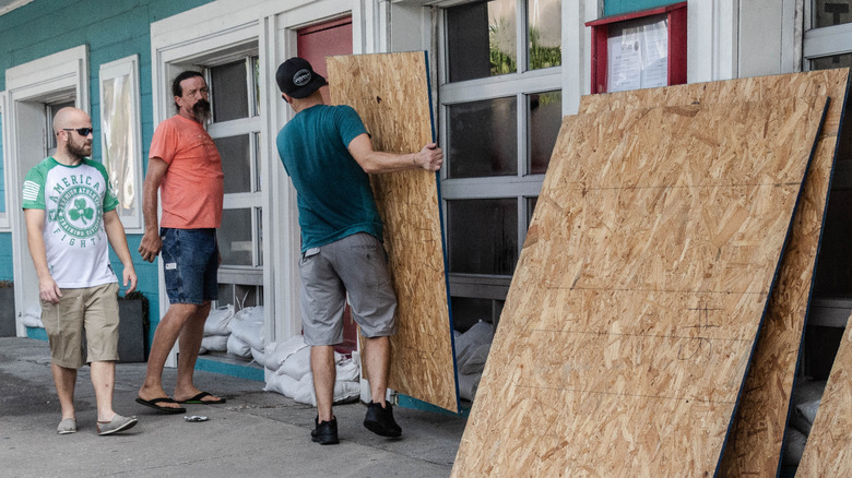 workers boarding restaurant windows