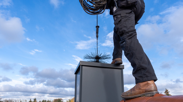 man cleaning chimney