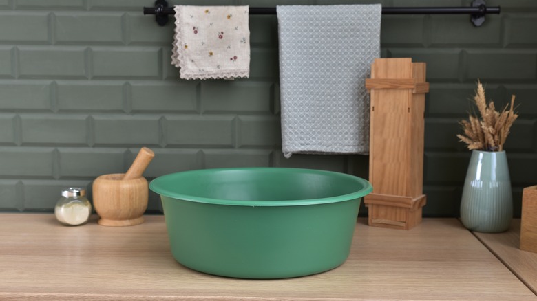 Green plastic basin on counter