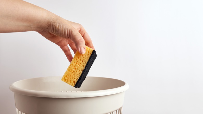 Hand dropping sponge in basket