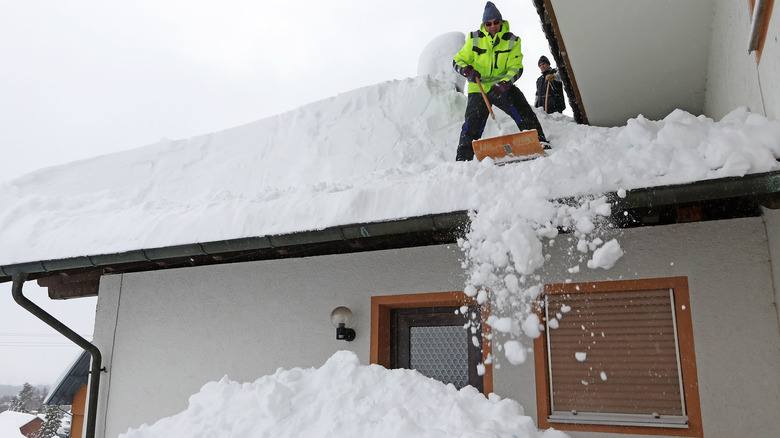 shoveling heavy snow from roof