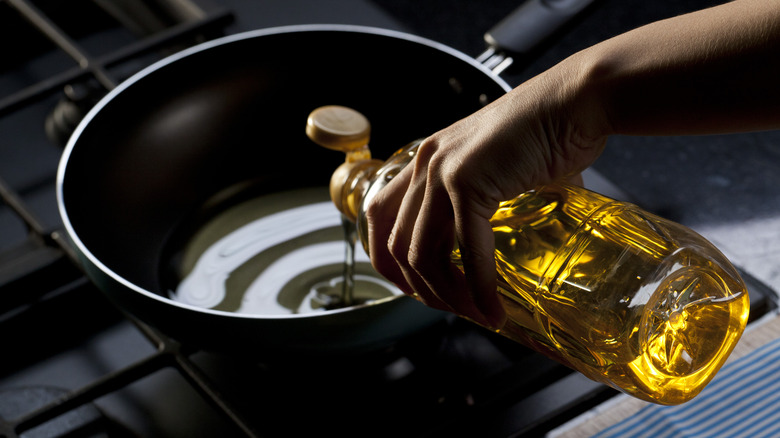 oil being poured into pan