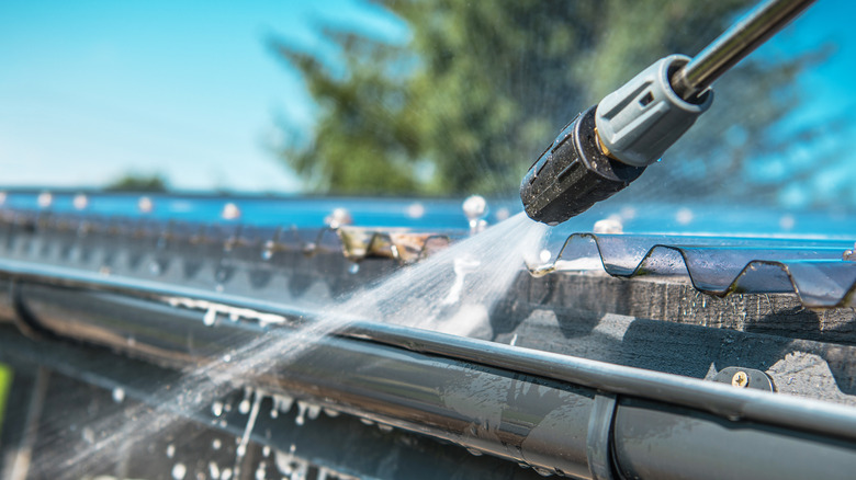 Up close pressure washing a gutter