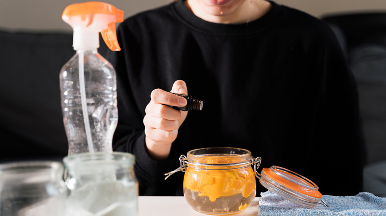 Woman making vinegar repellant