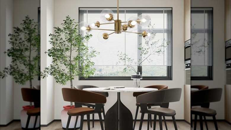 A Sputnik-style chandelier hangs over a breakfast table and chairs