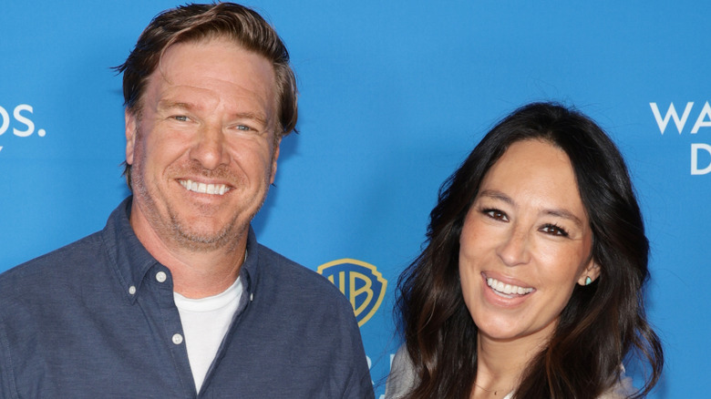 Chip and Joanna Gaines stand next to each other while smiling