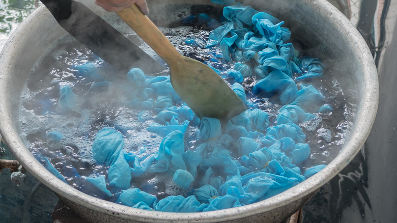 blue fabric boiling in pot 