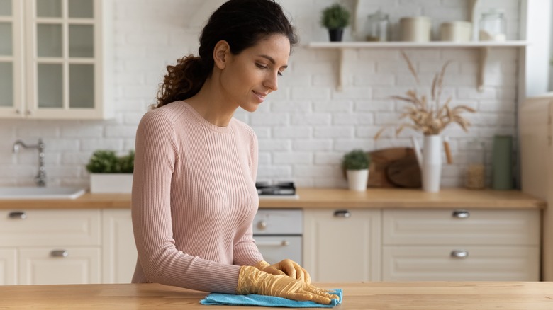 Woman polishing countertop