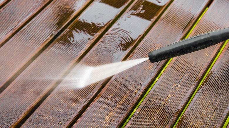 power washer cleaning a deck