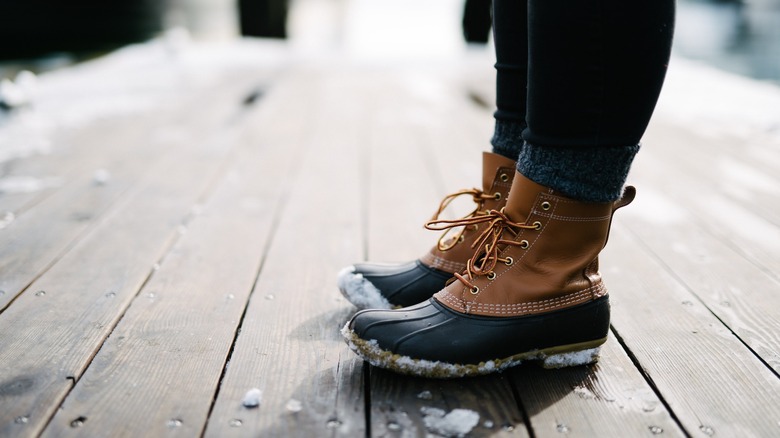 boots on snowy wood floor