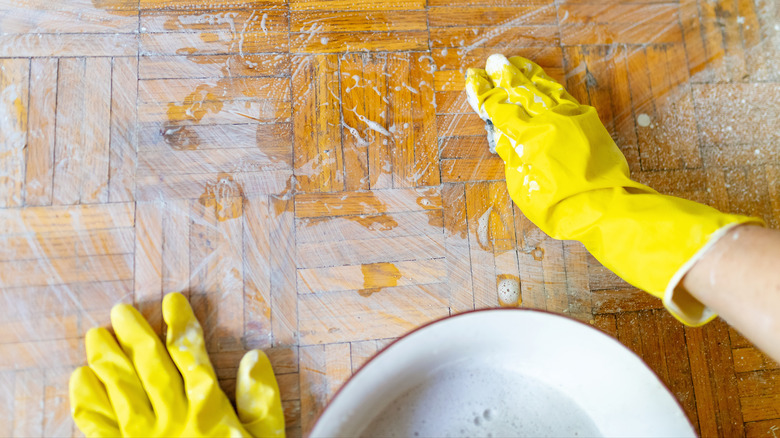 cleaning wood floor with soapy water