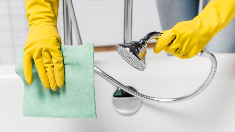 woman cleaning bathtub