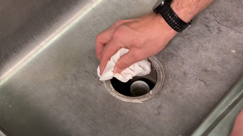 cleaning drain hole with paper towel