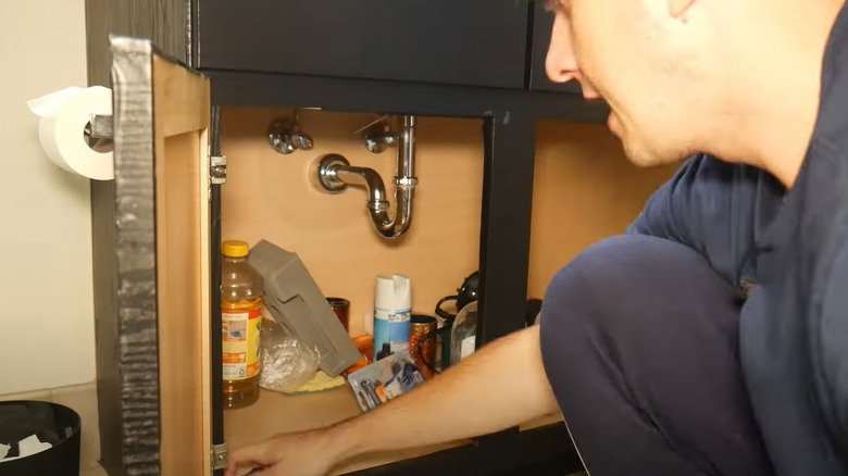 cluttered space under sink