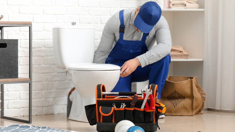 Person removing a toilet