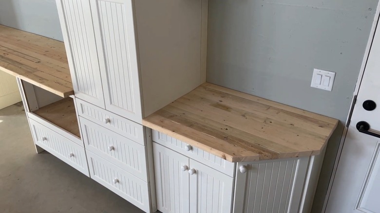 Old kitchen cabinets repurposed for garage storage