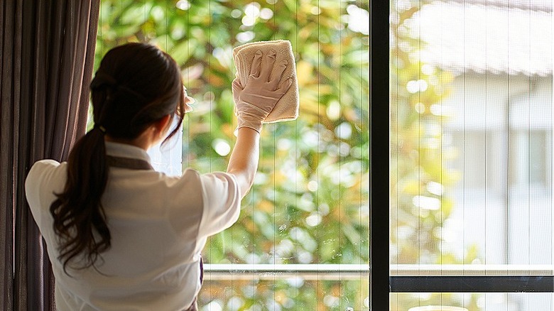 Person wiping glass