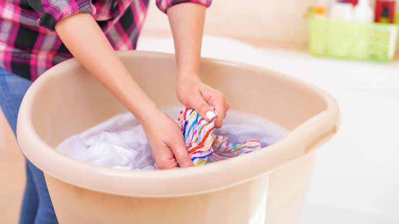 clothes in bucket of water