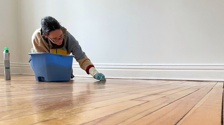 Woman cleaning hardwood floors